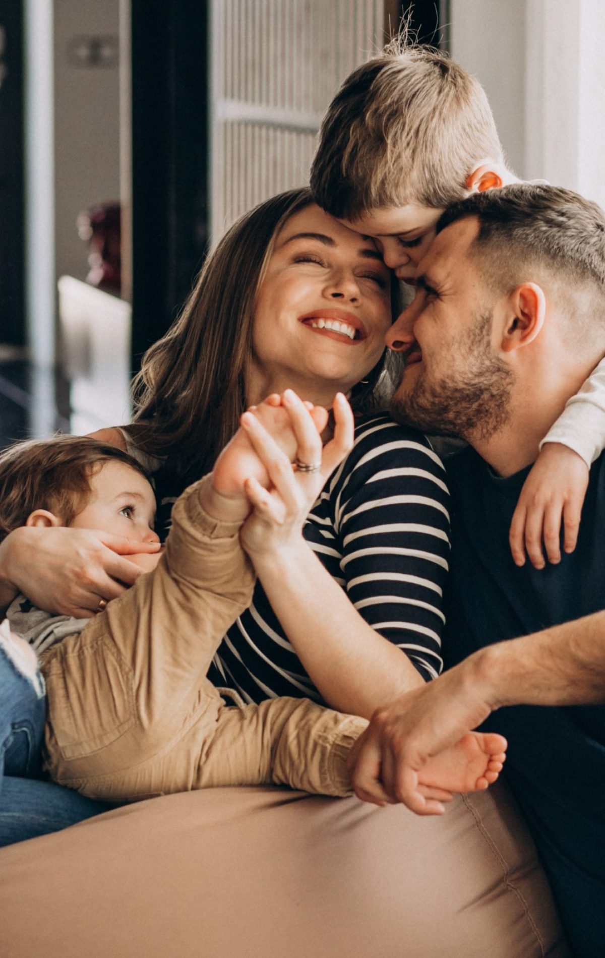 Young family with their sons at home having fun